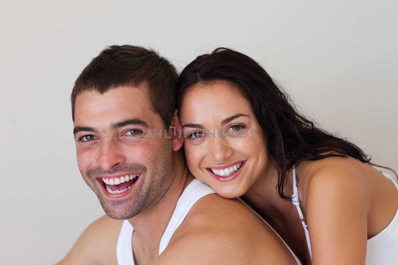 Smiling Romantic Couple relaxing in each others Company at home