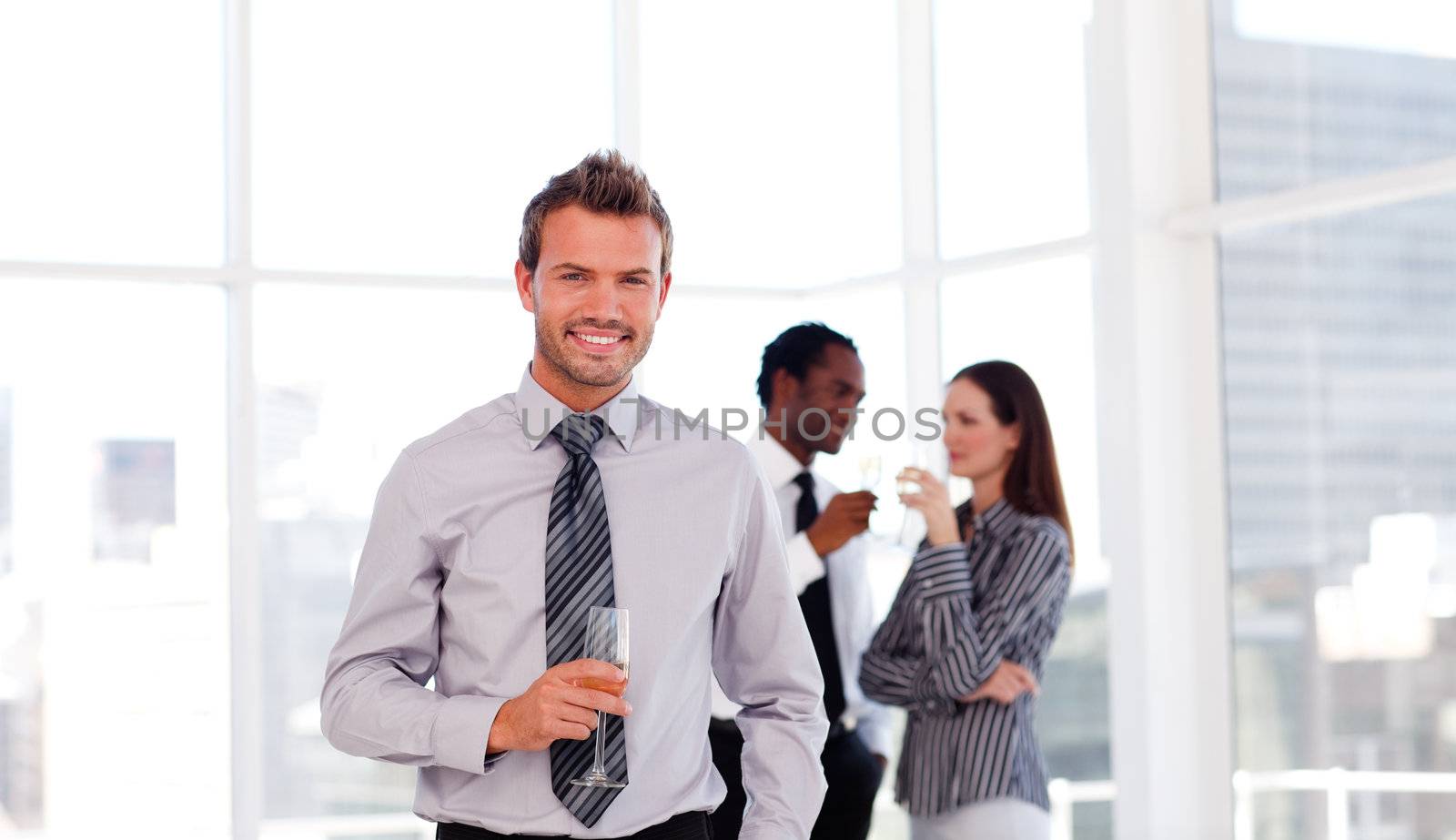 Happy businessman in the office with his team by Wavebreakmedia