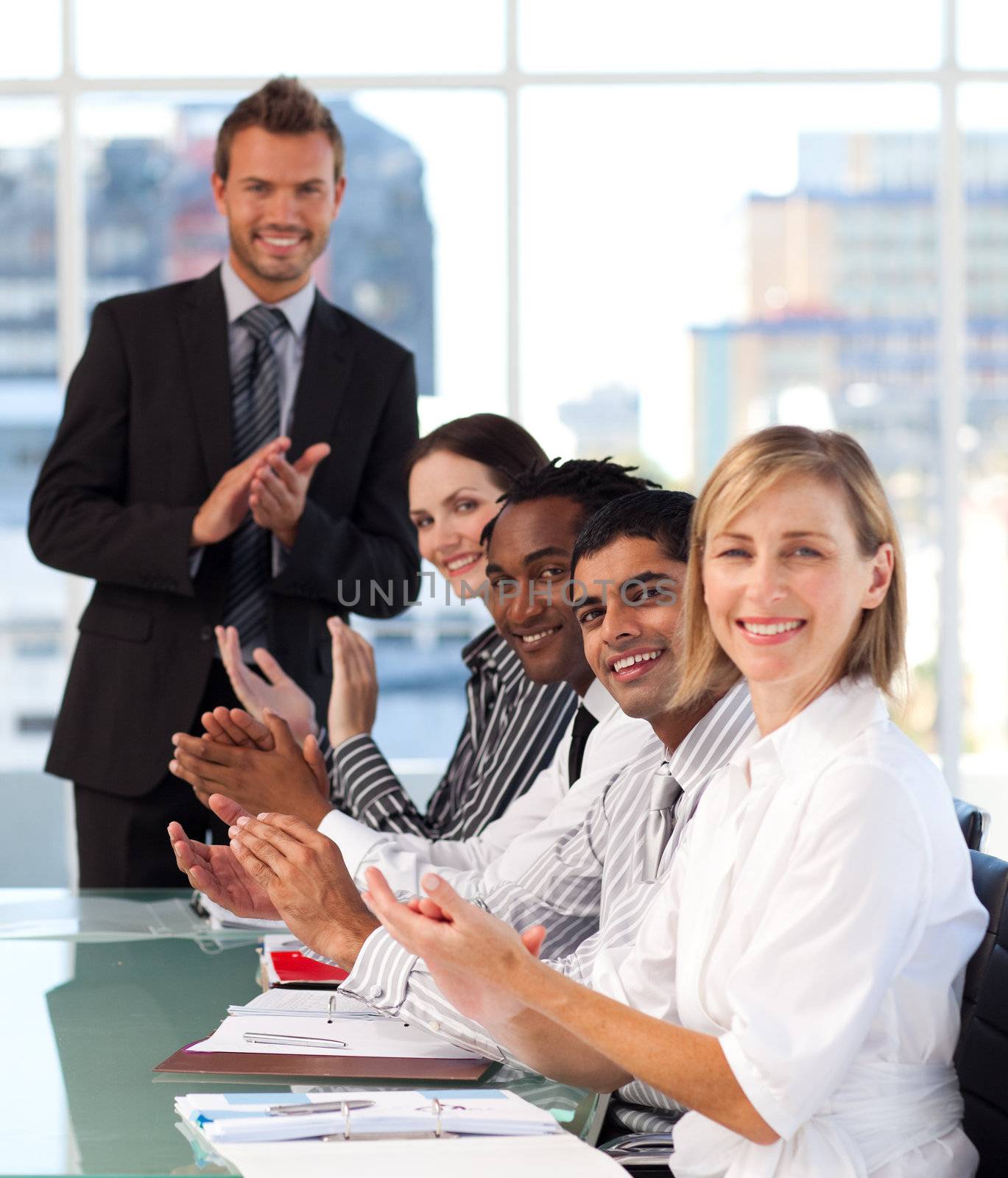 International business team clapping in a meeting