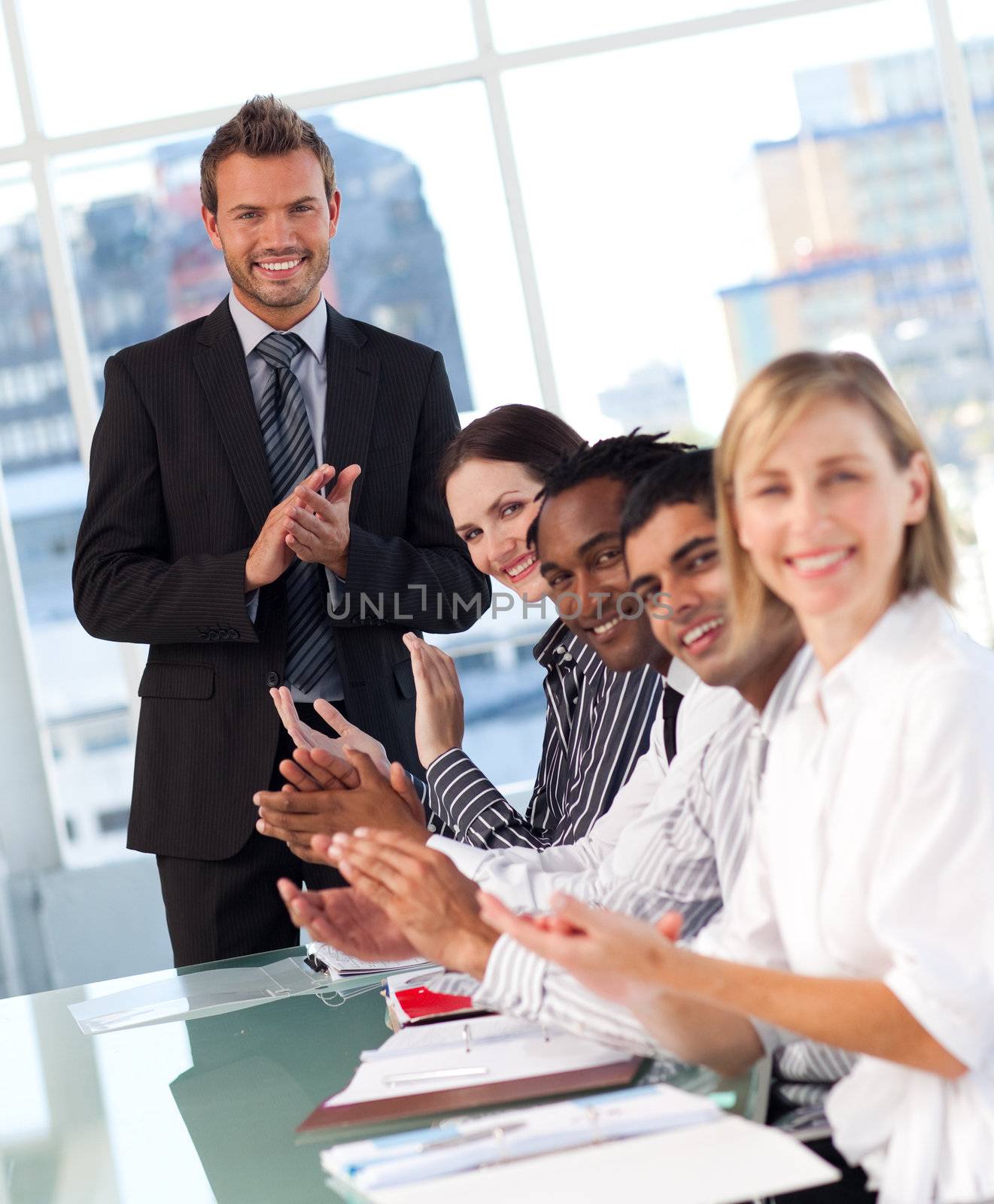 International business team applauding in a meeting