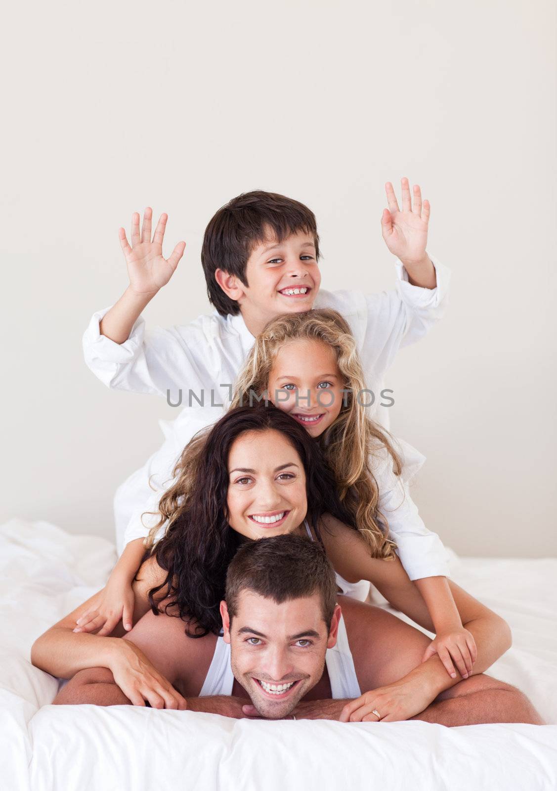 Cheerful family lying on their bed
