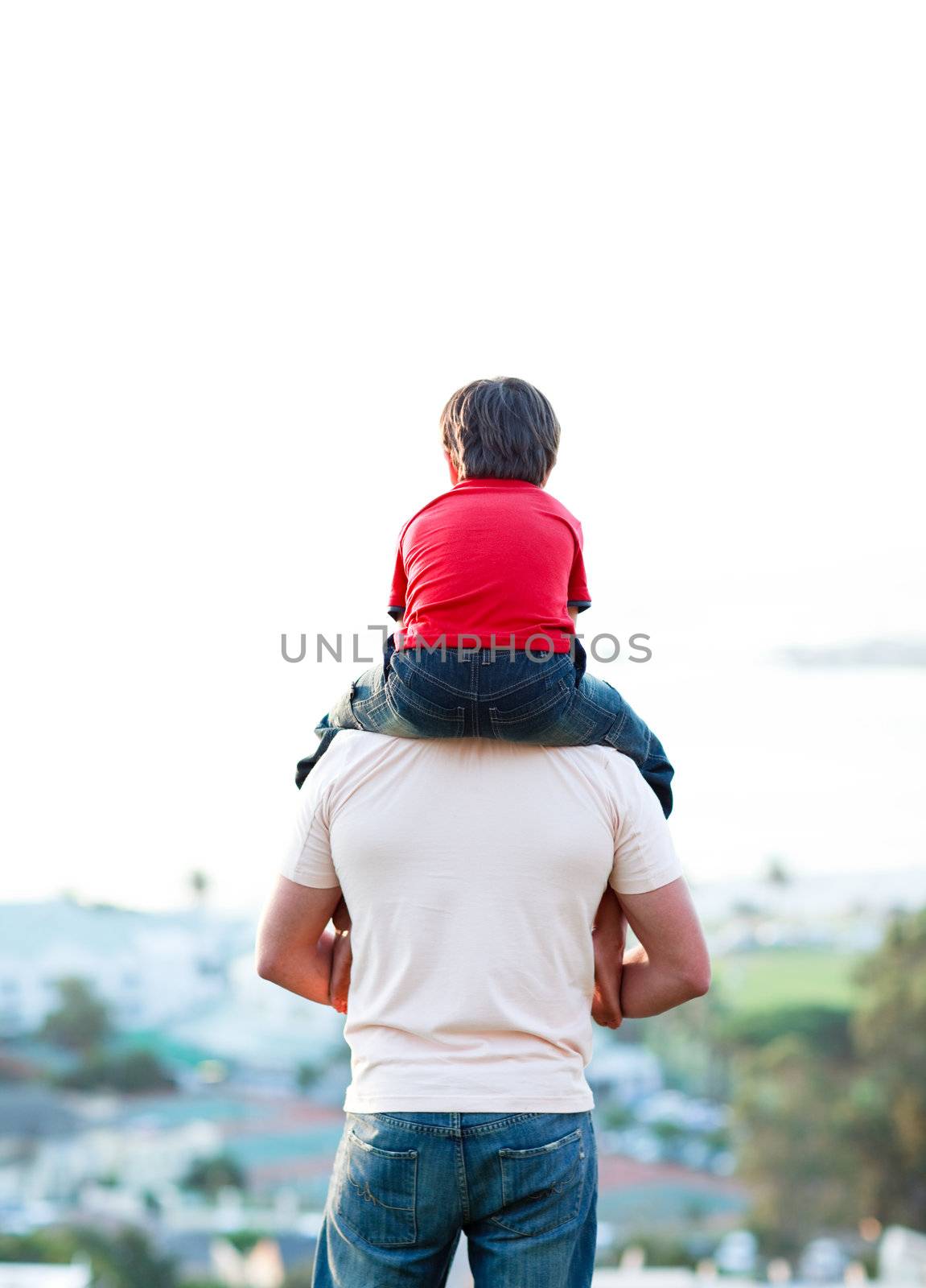 Young man giving child piggyback ride outdoors