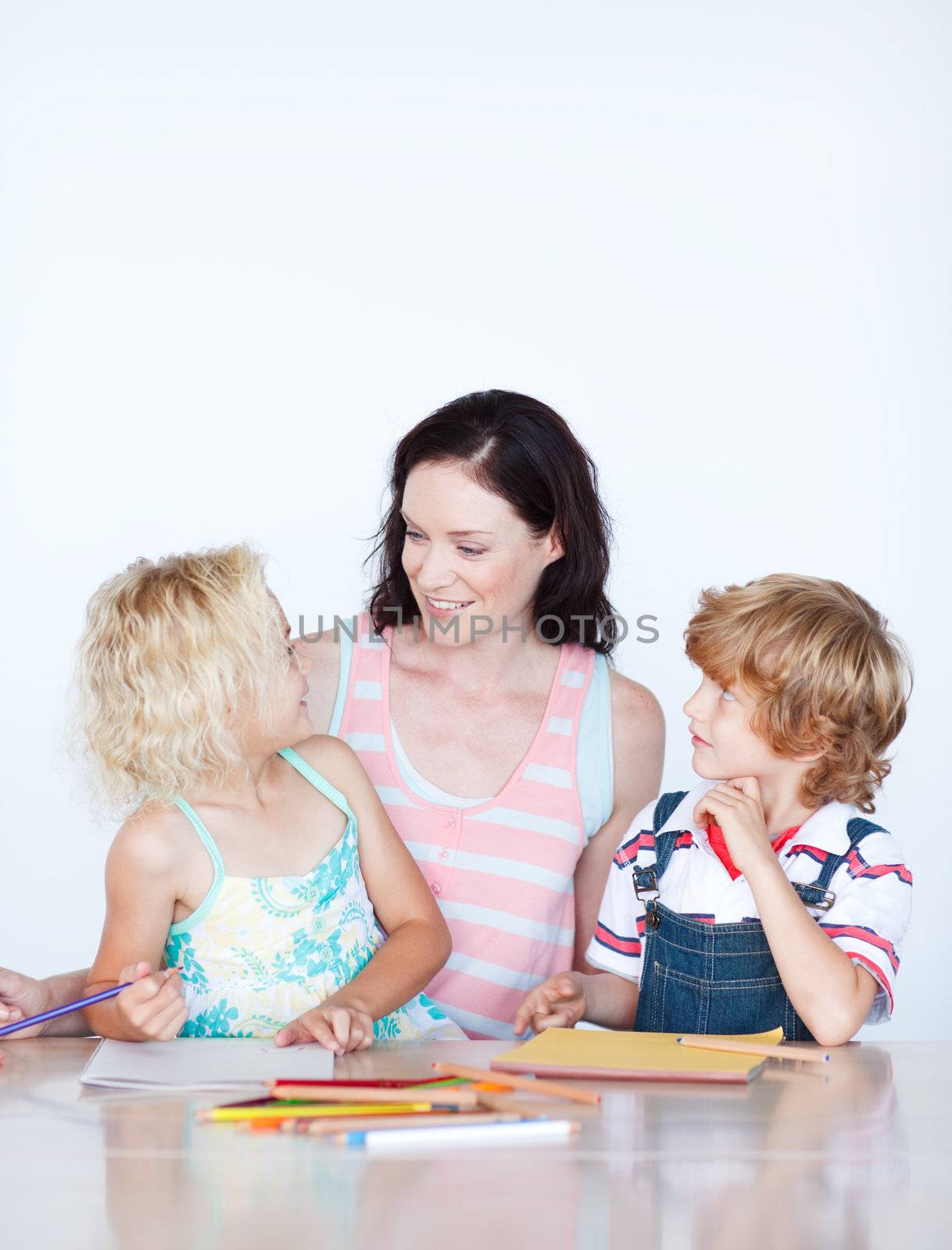 Mother helping her children doing homework by Wavebreakmedia