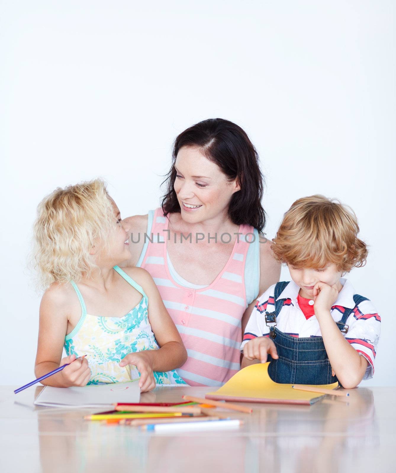 Mother and children drawing together at home