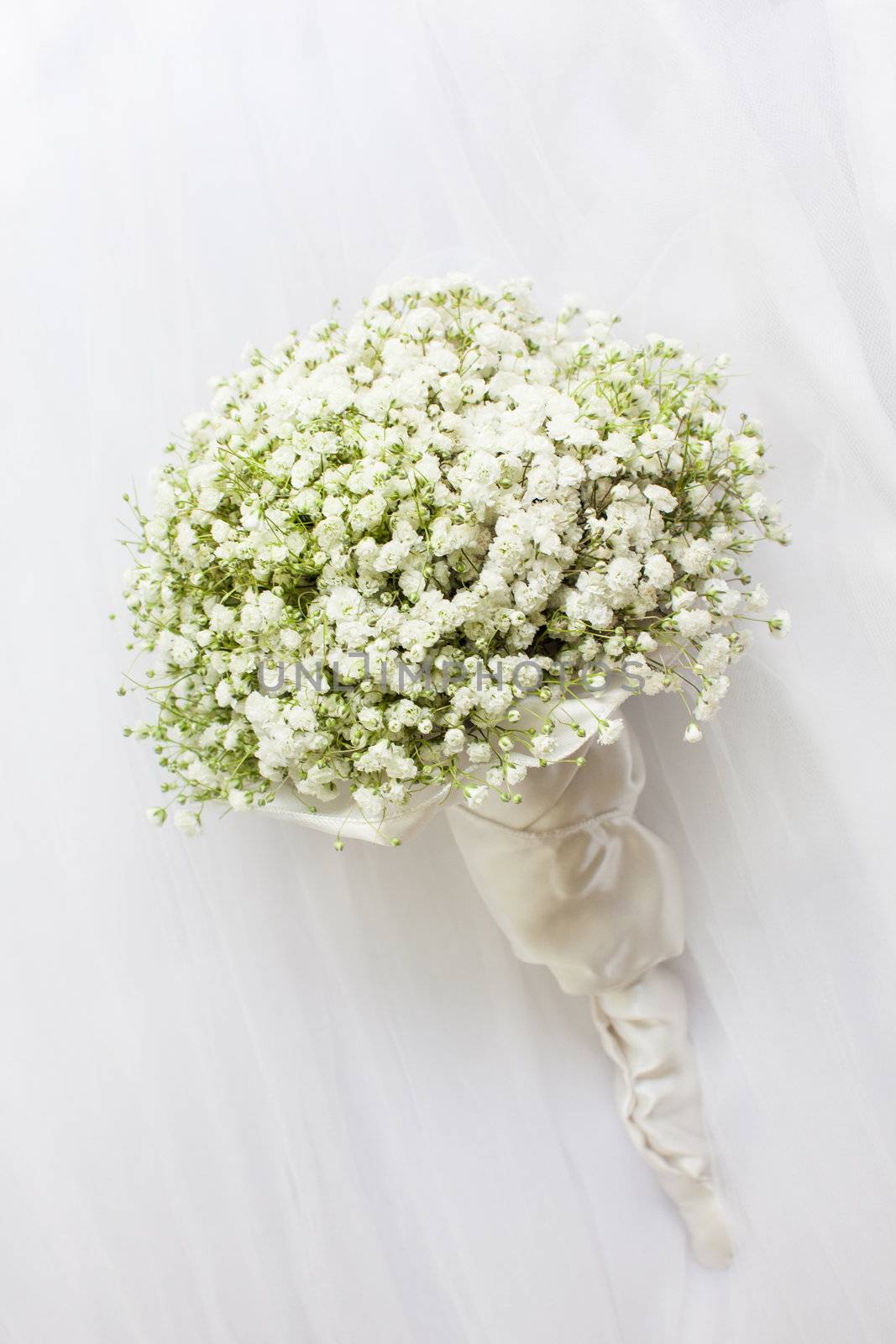 Wedding bouquet on a white vail.