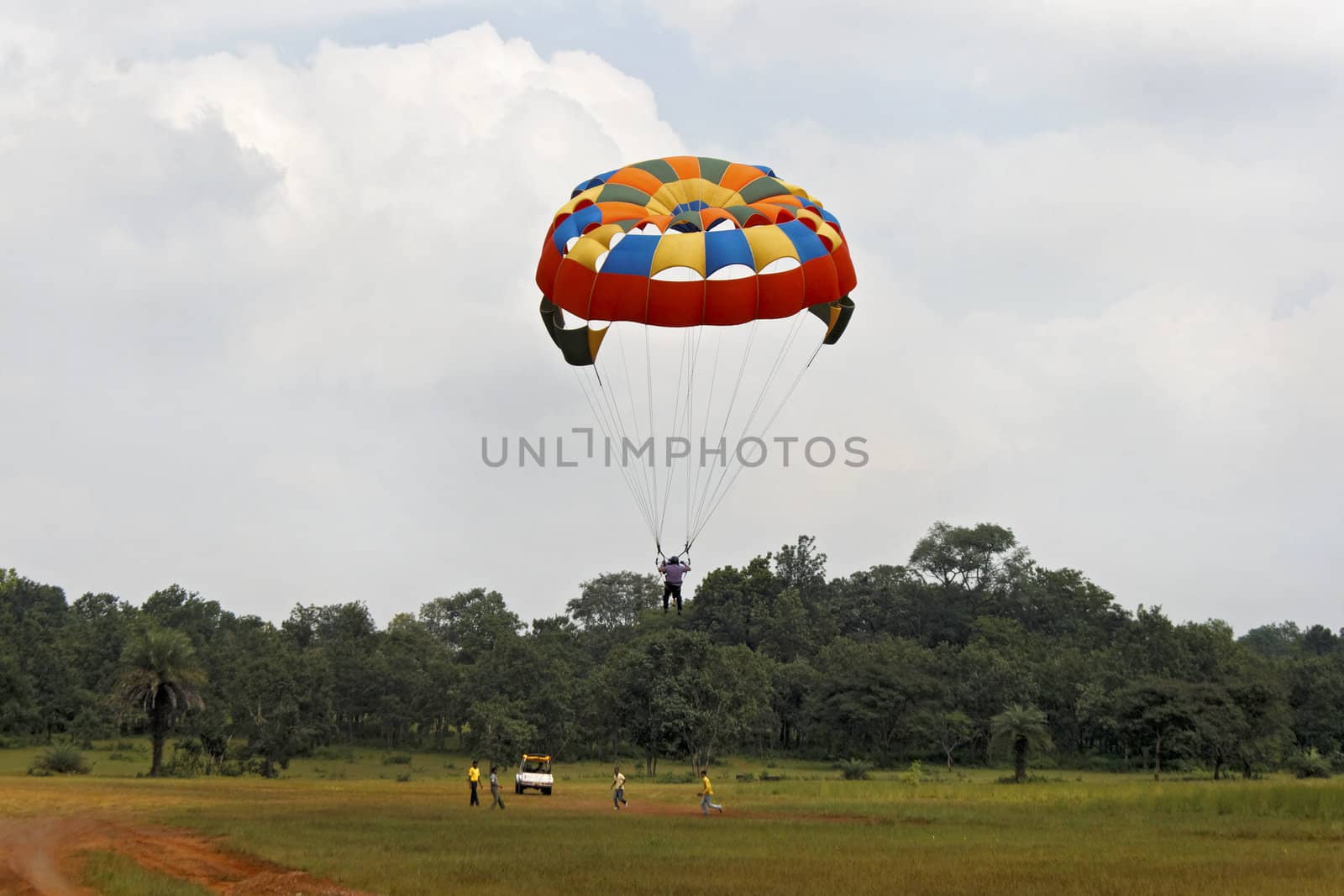 Generic landscape of a pair of male para gliders sailing amongst blue skies and clouds. Location could have been any where but this shot is take in Pachmarhi, Madhya Pradesh, India