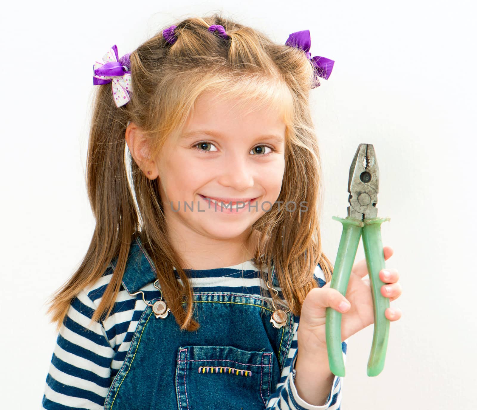 little smiling girl with old pliers
