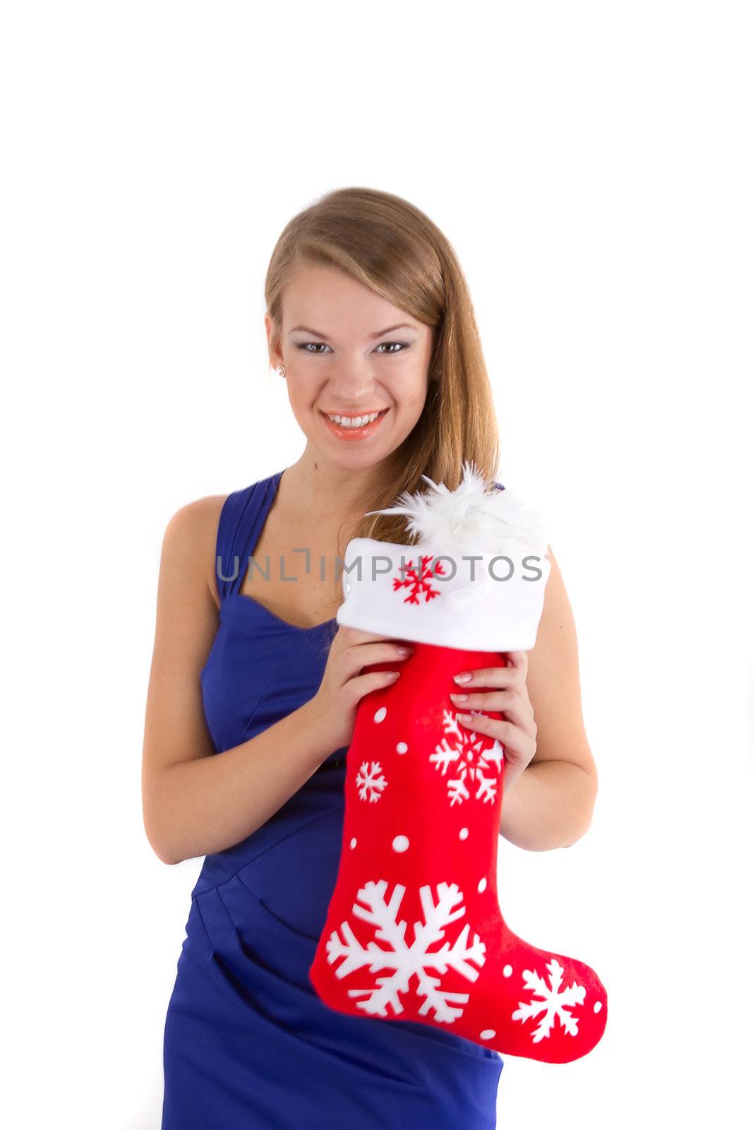 smiling girl in a blue dress with long hair holding a red Christmas sock