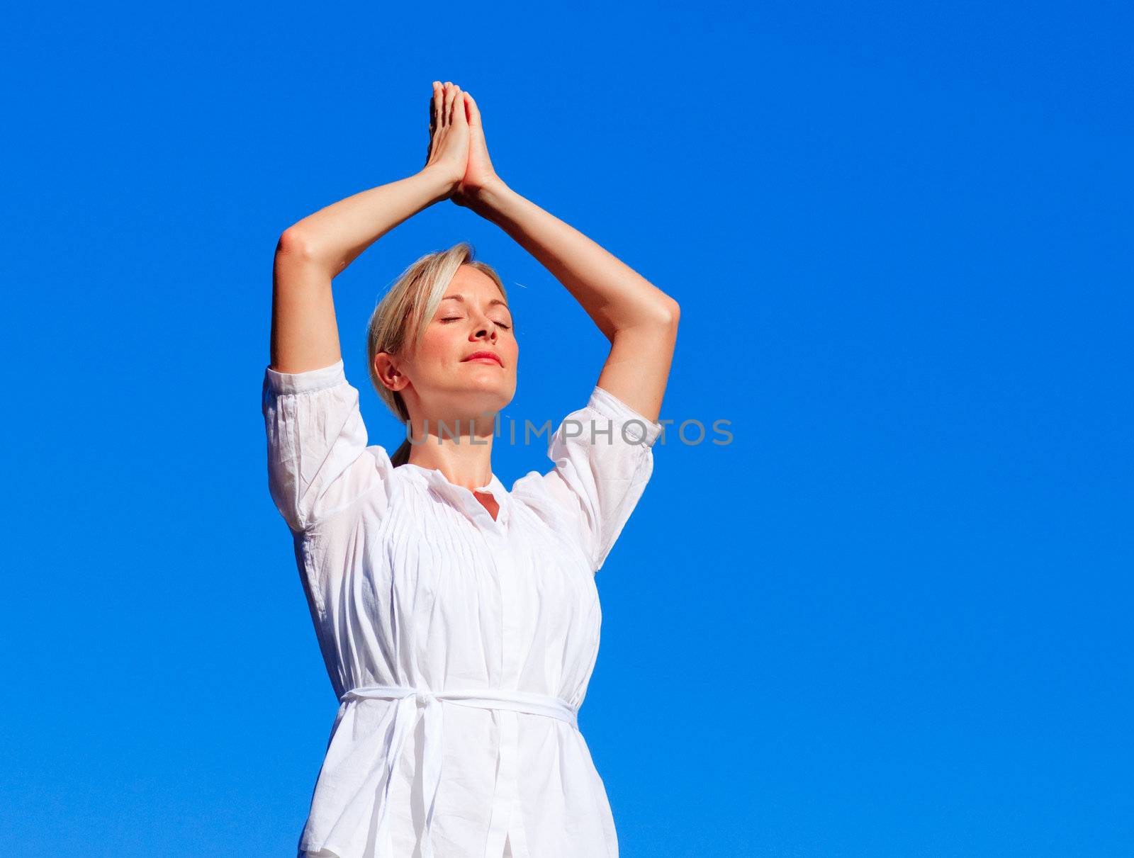 Beautiful woman practising yoga  by Wavebreakmedia