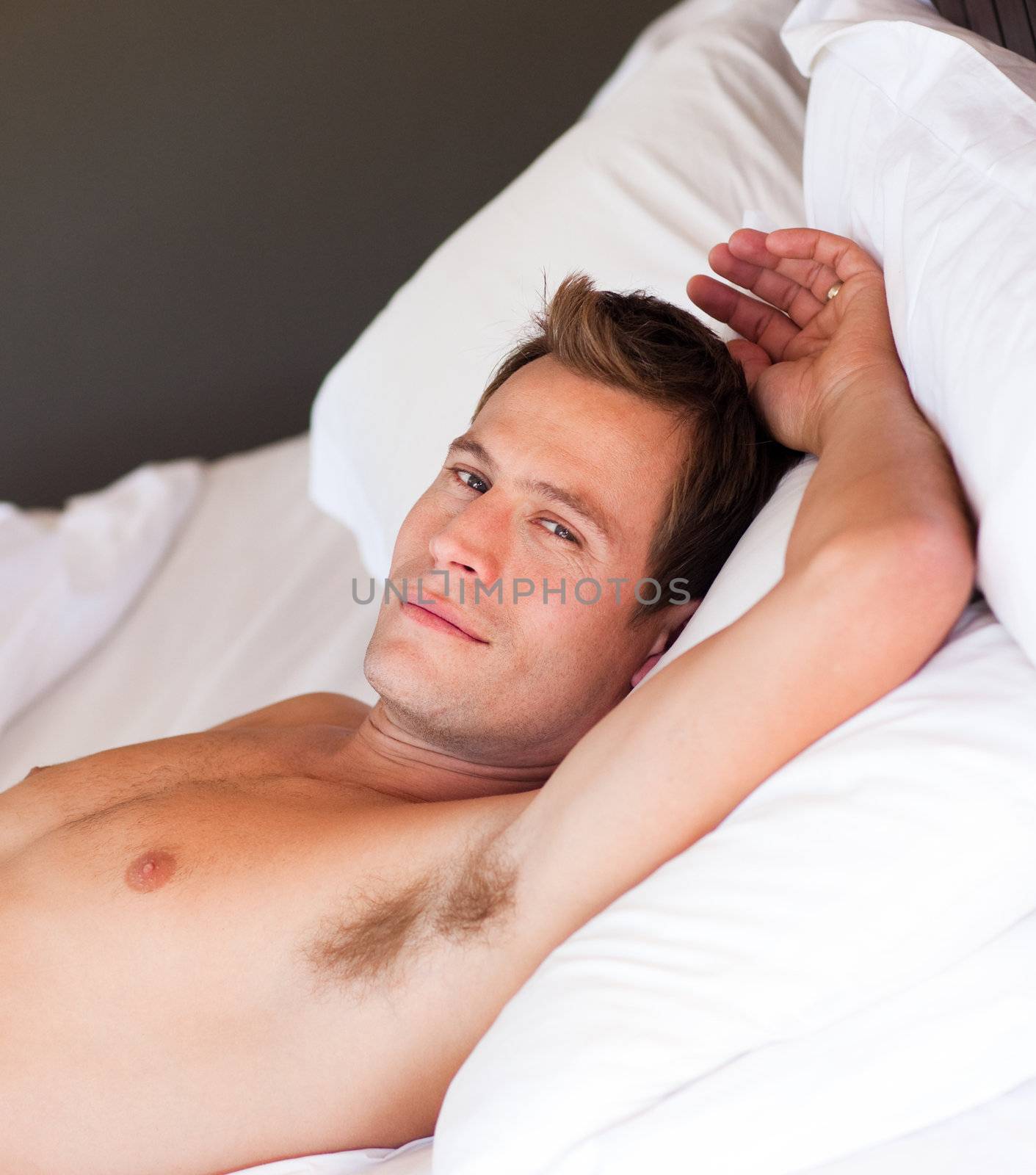 Portrait of an isolated young man relaxing in bed