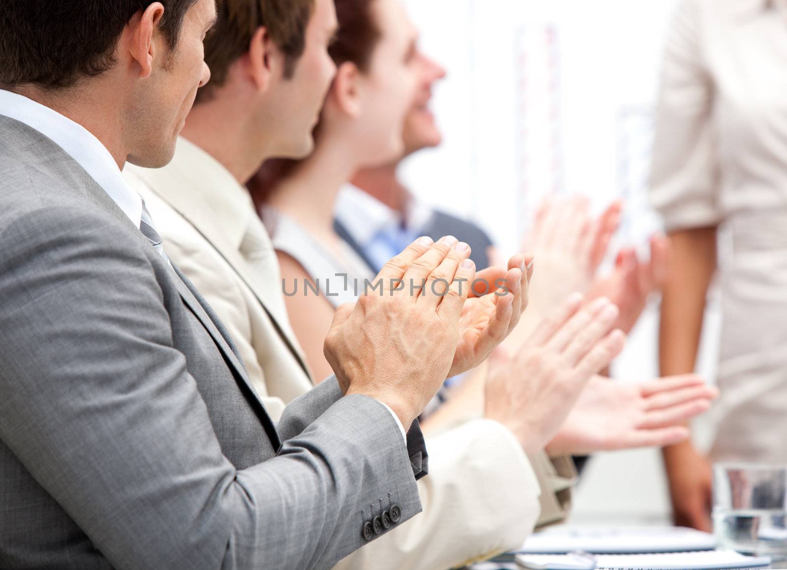 Portrait of a businessteam applauding during a meeting by Wavebreakmedia