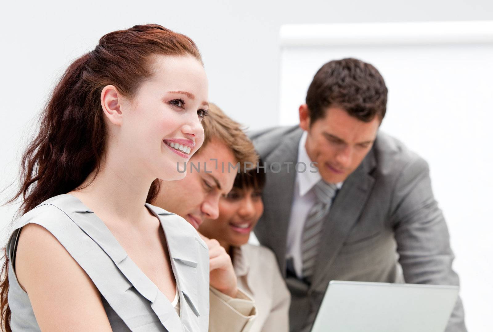 Portrait of a smiling businesswoman working with her colleagues in the office