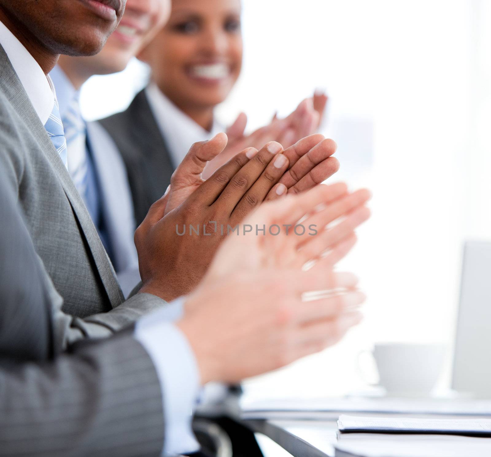 Close up of a  mixed business team applauding a presentation  by Wavebreakmedia