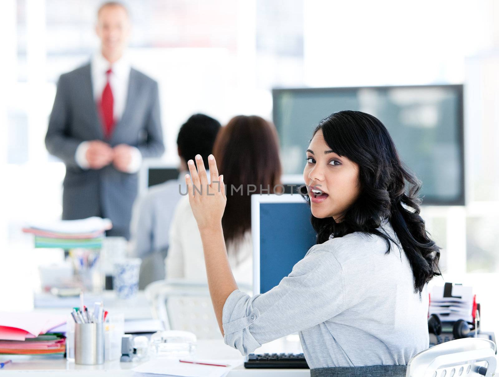Portrait of a interrested businesswoman raising her hand in the office