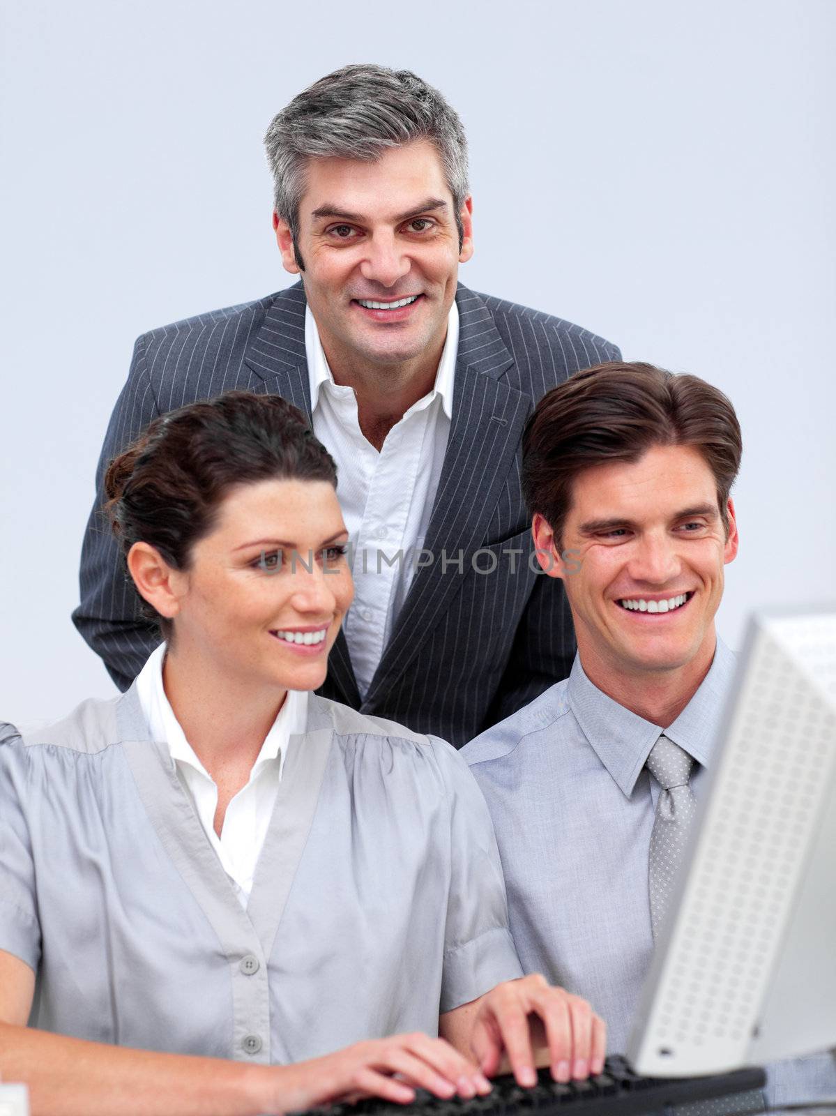 Enthusiastic businessteam working at a computer in the office