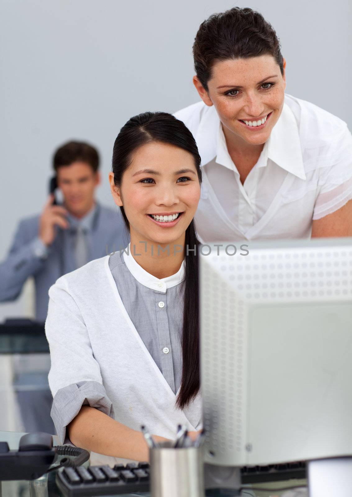 Attractive manager checking her employee's work in the office