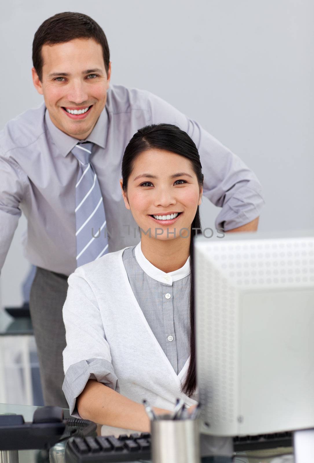 Attractive businesswoman helping by her manager in the office