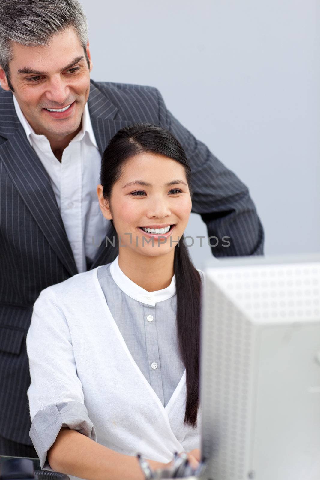 Smiling businesswoman helping by her manager in the office