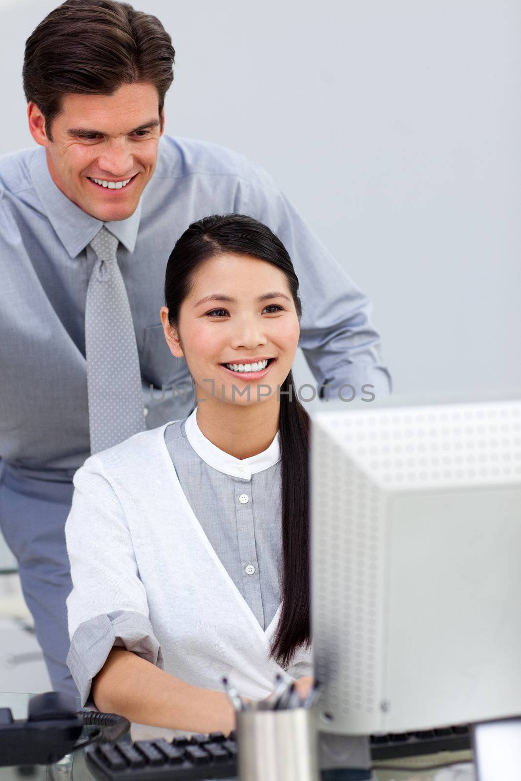 Cheerful businesswoman helping by her manager in the office
