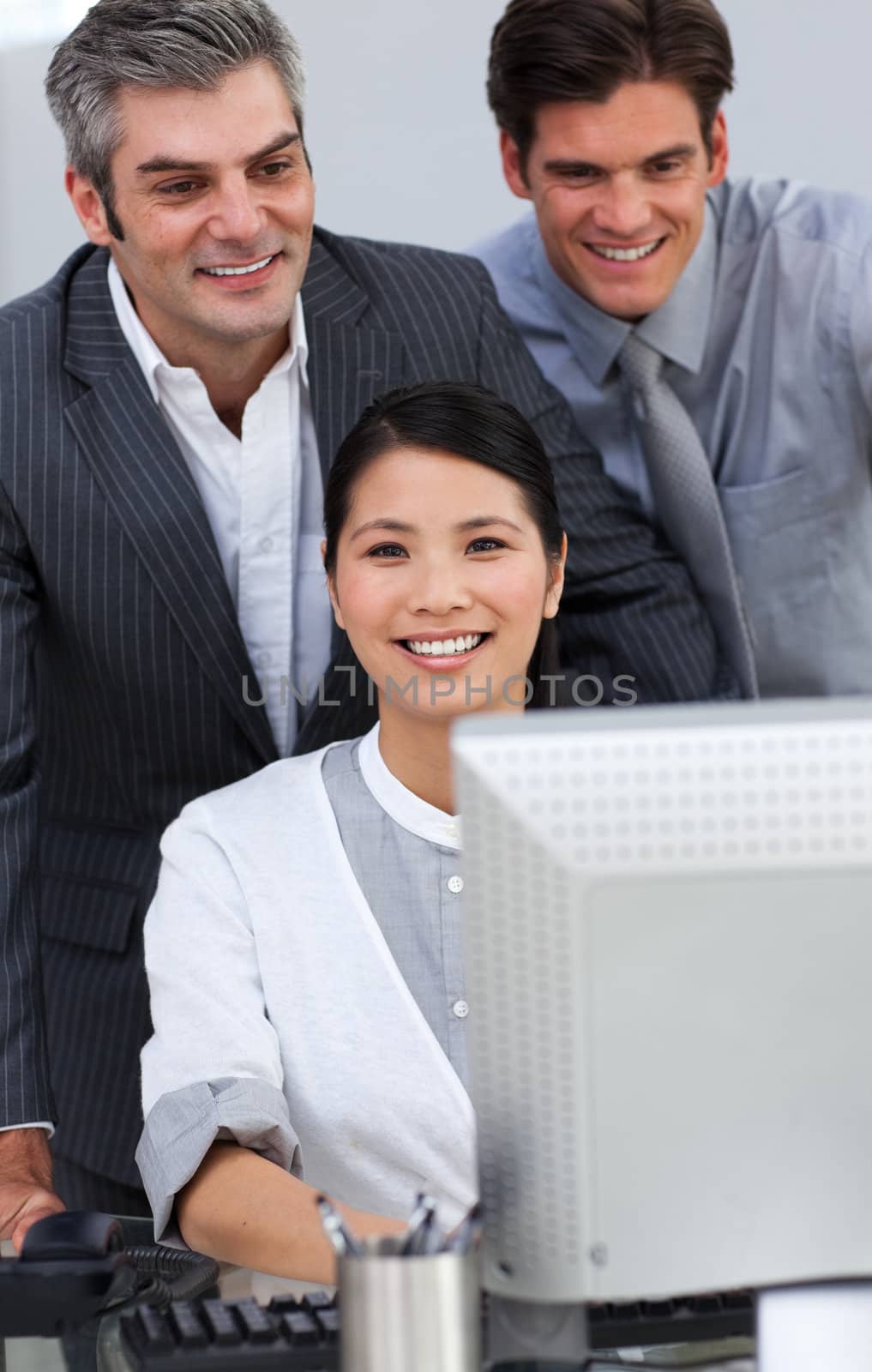 Positive business people working together at a computer by Wavebreakmedia