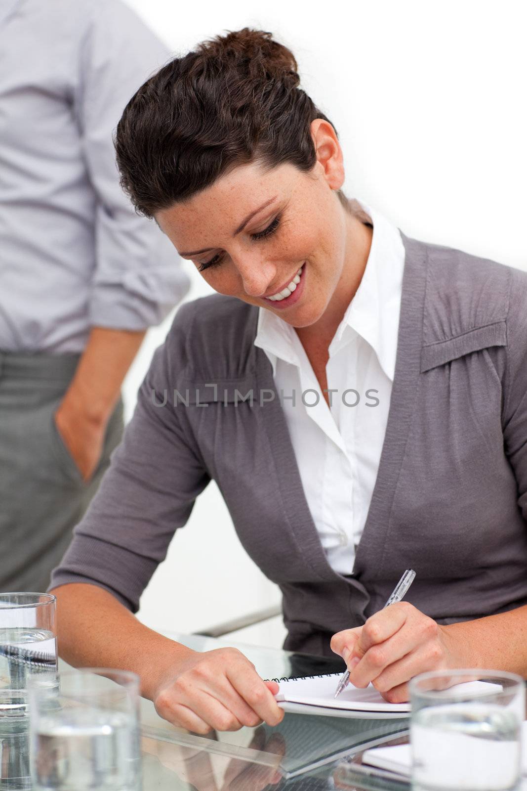Attractive businesswoman taking notes  by Wavebreakmedia