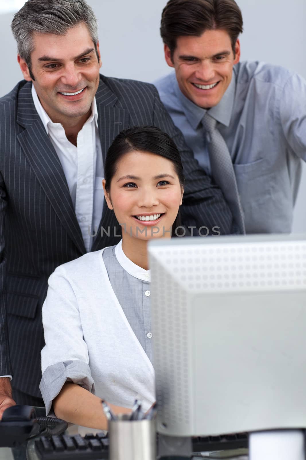 Smiling business partners working together at a computer  by Wavebreakmedia