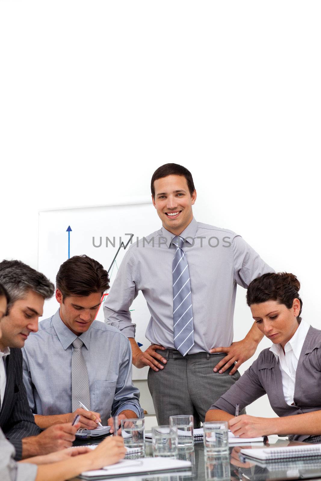Young businessman reporting sales figures in a meeting