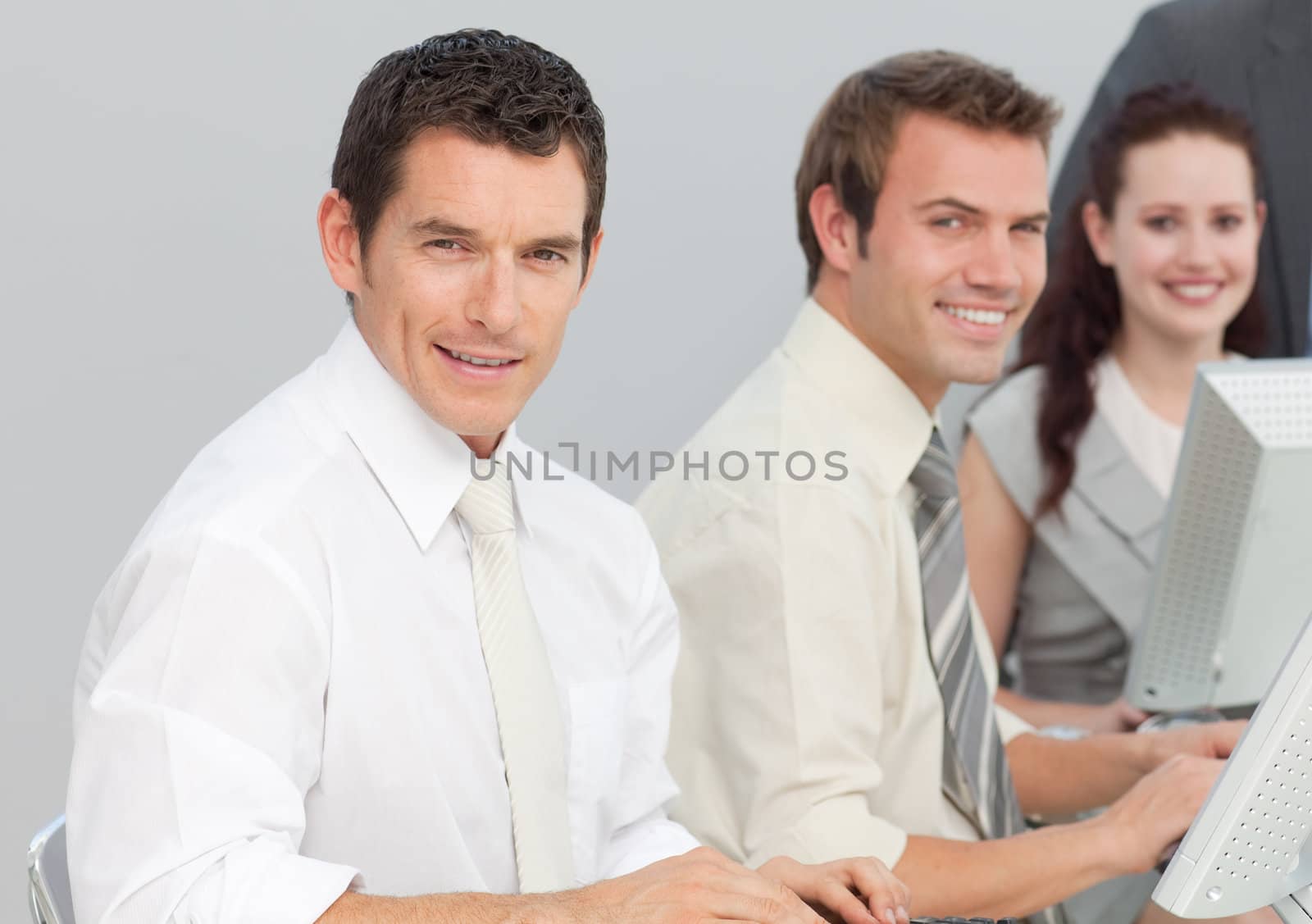 Young business people using computers in an office