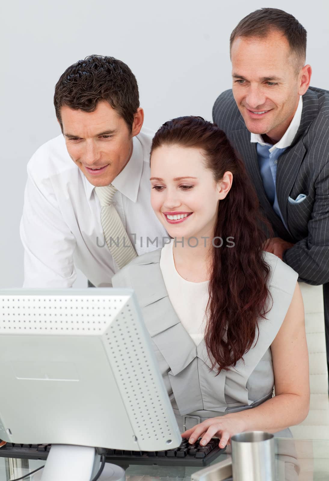 Three business people using a computer by Wavebreakmedia