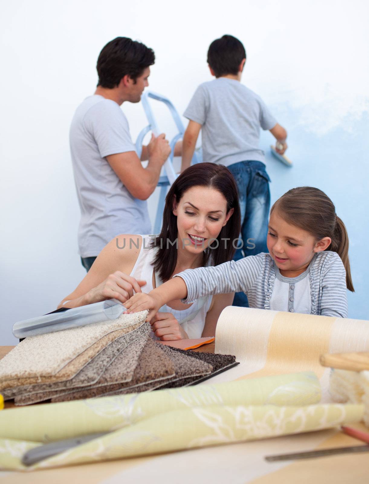 Happy Young family renovating home after moving