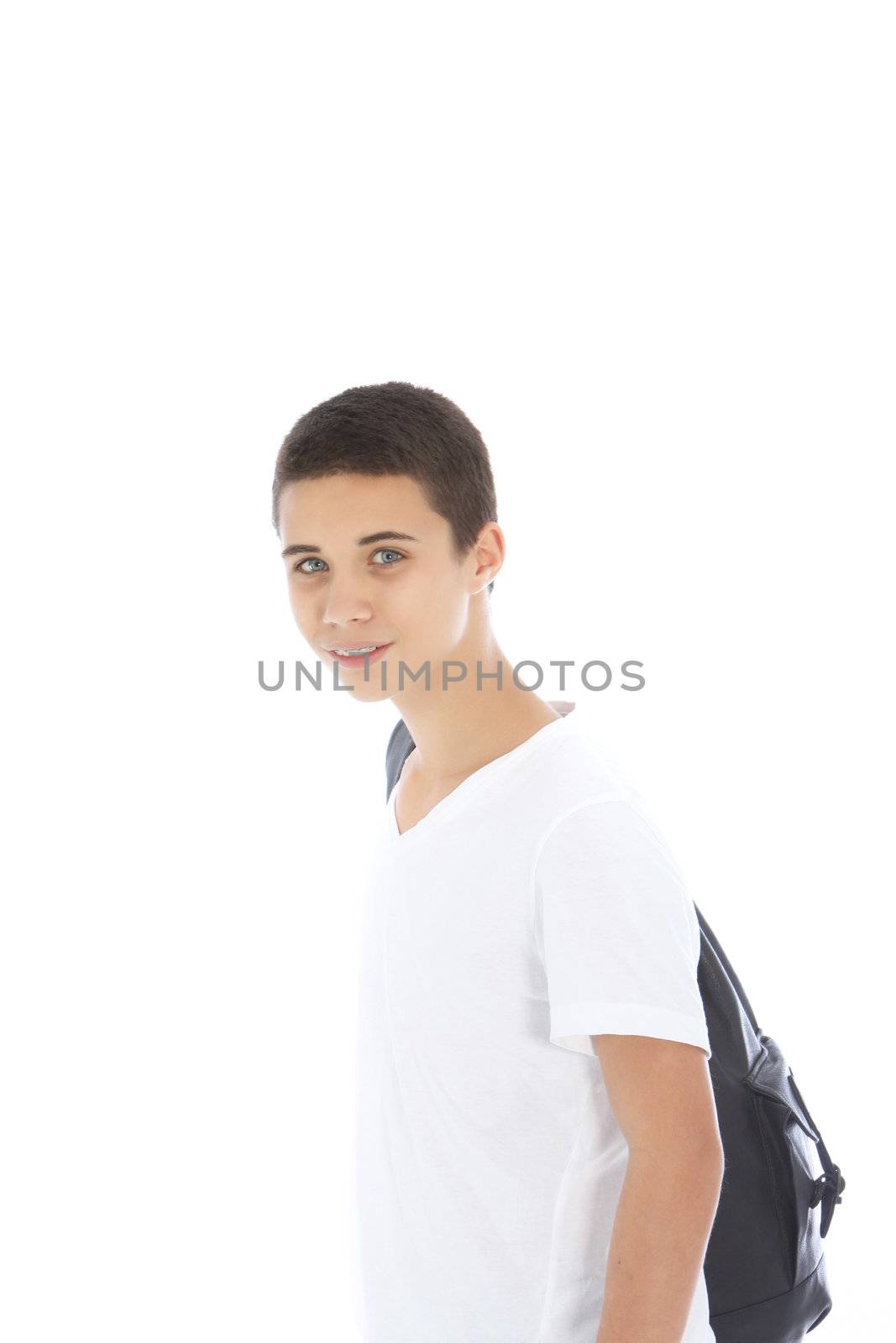 Young teenage boy standing sideways with a kit bag slung over his shoulder isolated on white