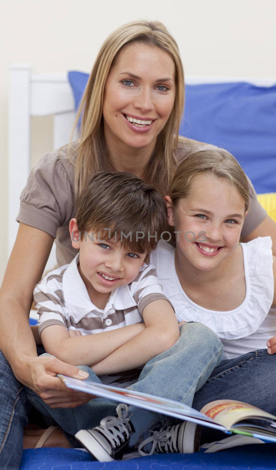 Portrait of mother reading a book with her children by Wavebreakmedia