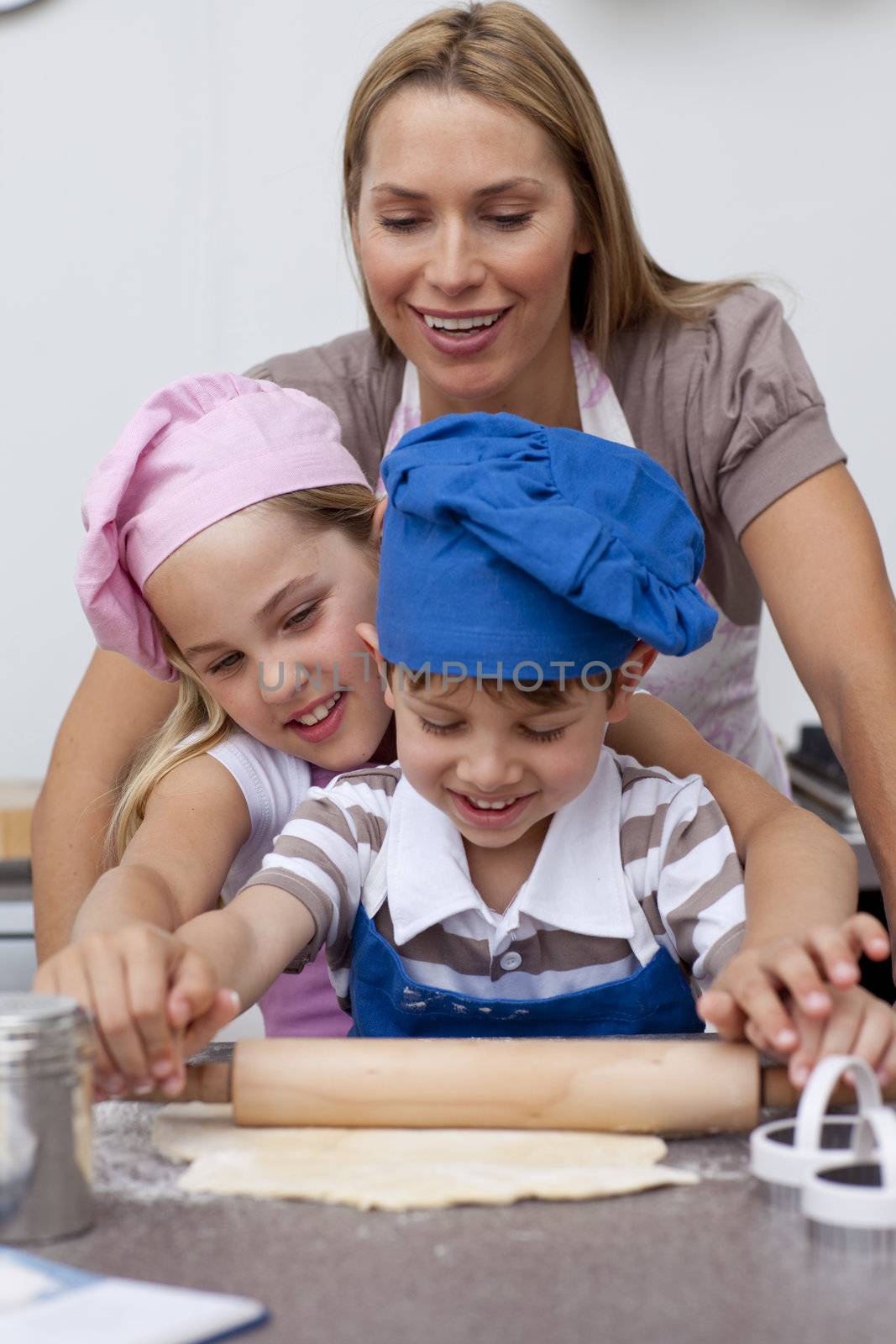 Mother and children baking cookies in the kitchen by Wavebreakmedia