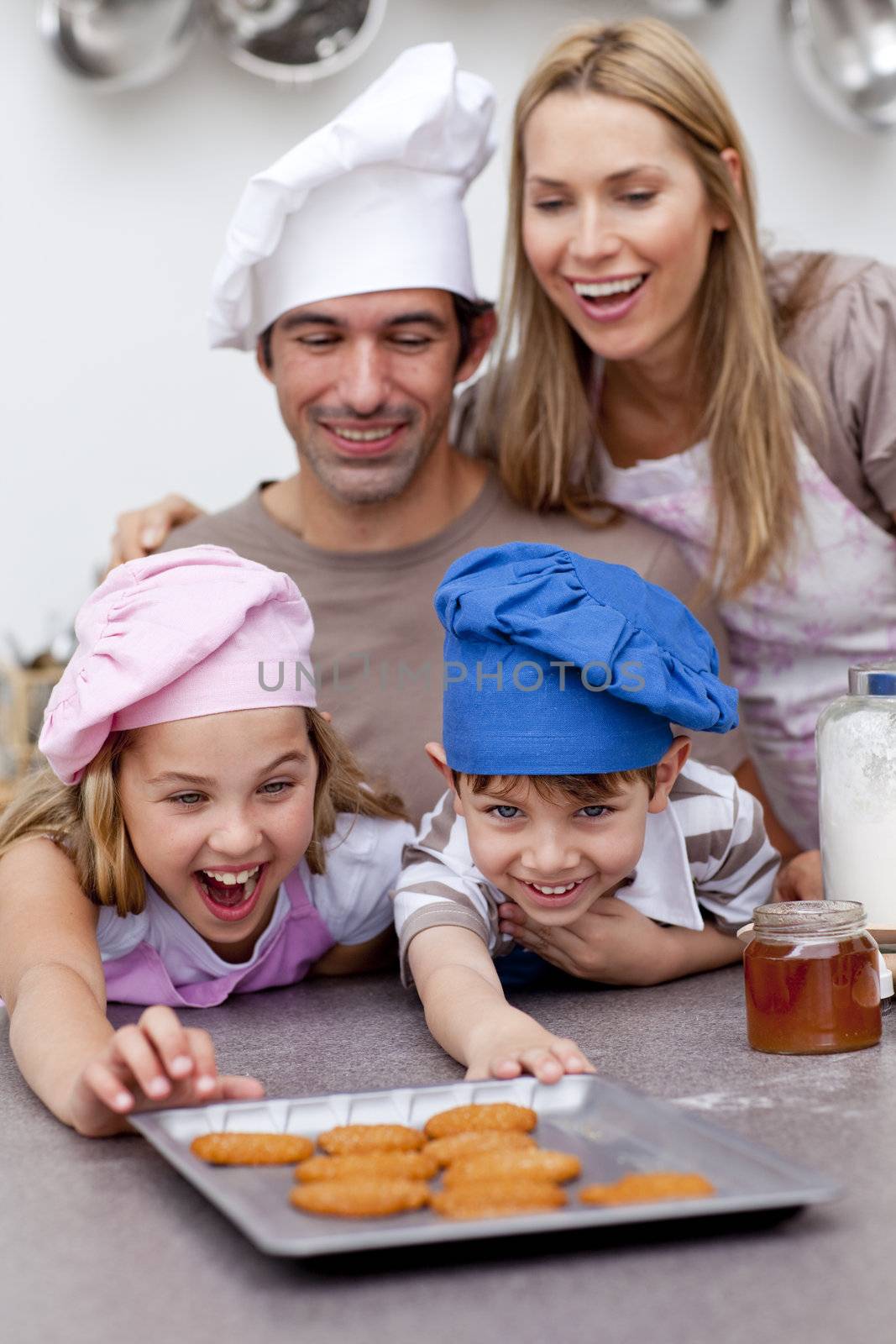 Children and parents eating cookies after baking by Wavebreakmedia