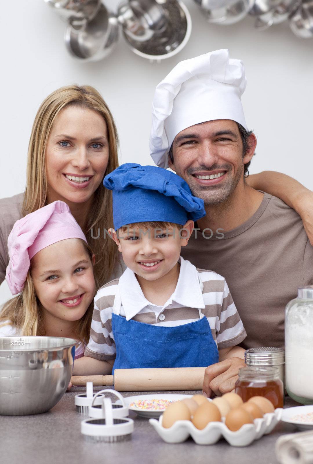 Portrait of family baking cookies in the kitchen
