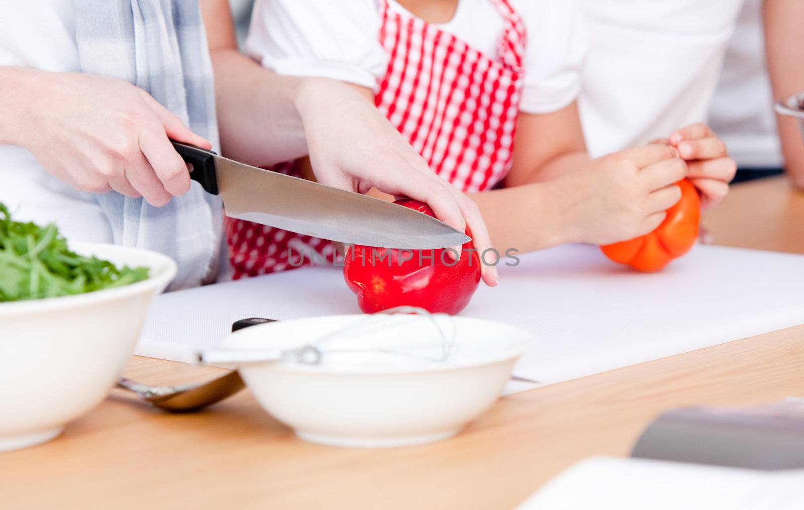 Close-up of people preparing a meal  by Wavebreakmedia