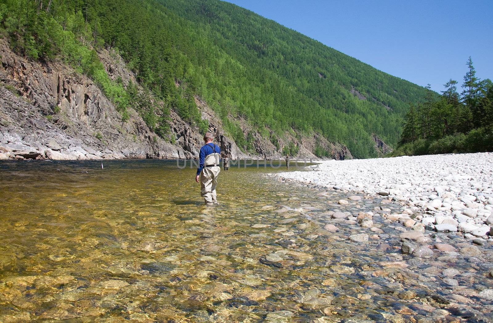 fisherman fishing on a mountain river in Siberia