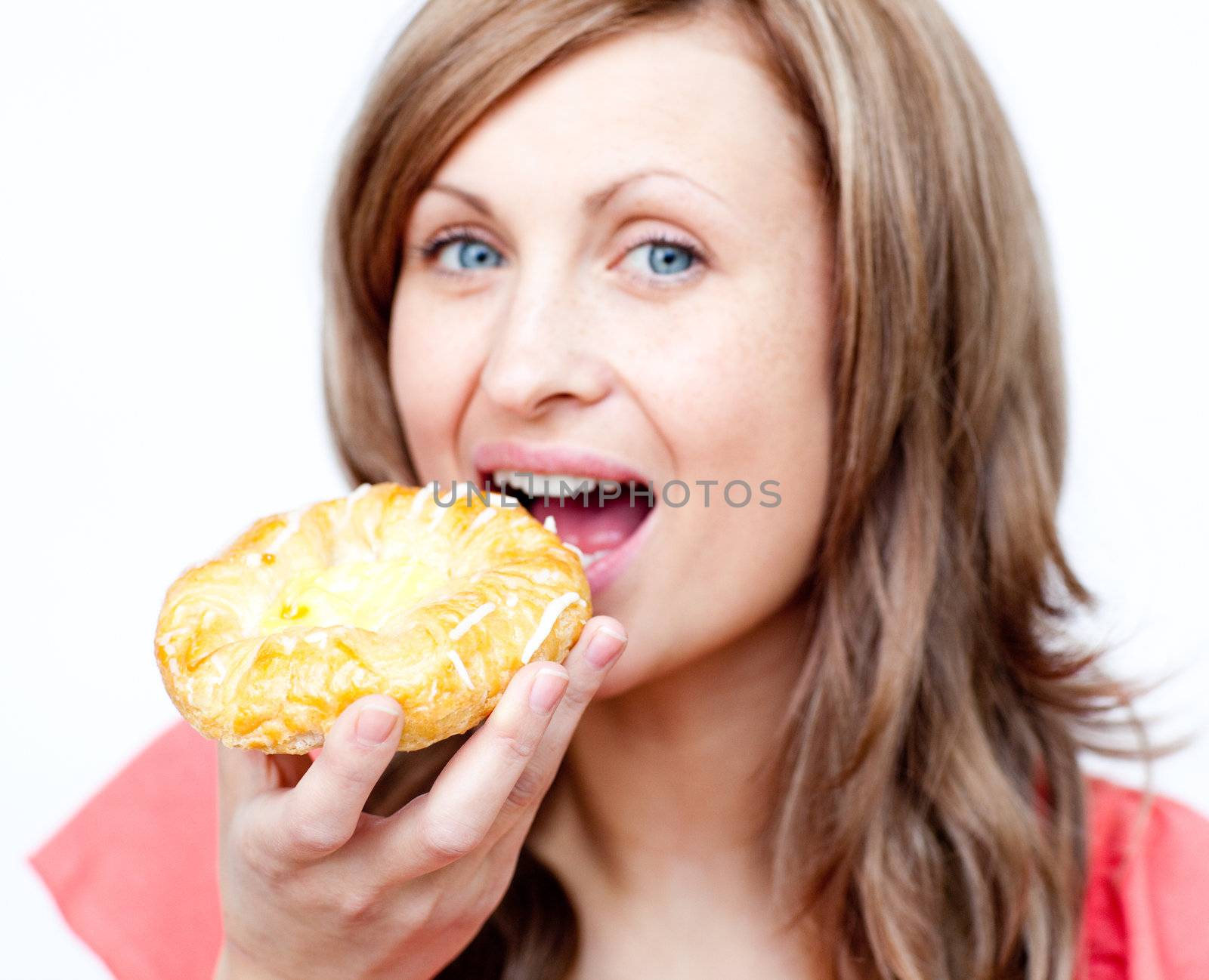 Attractive woman eating a cake by Wavebreakmedia