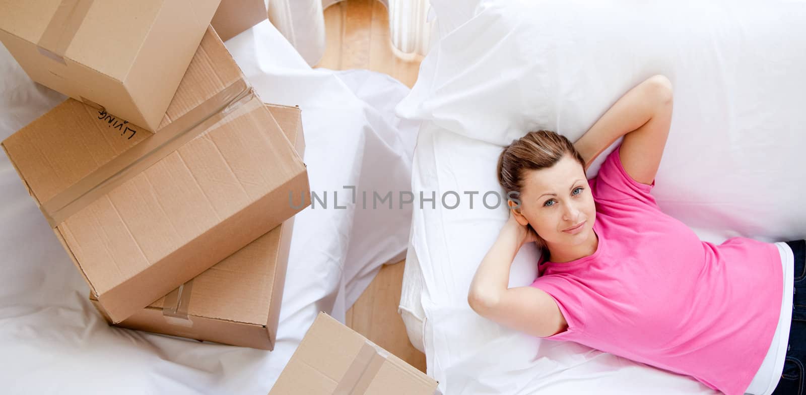 Cheerful woman relaxing between boxes at home