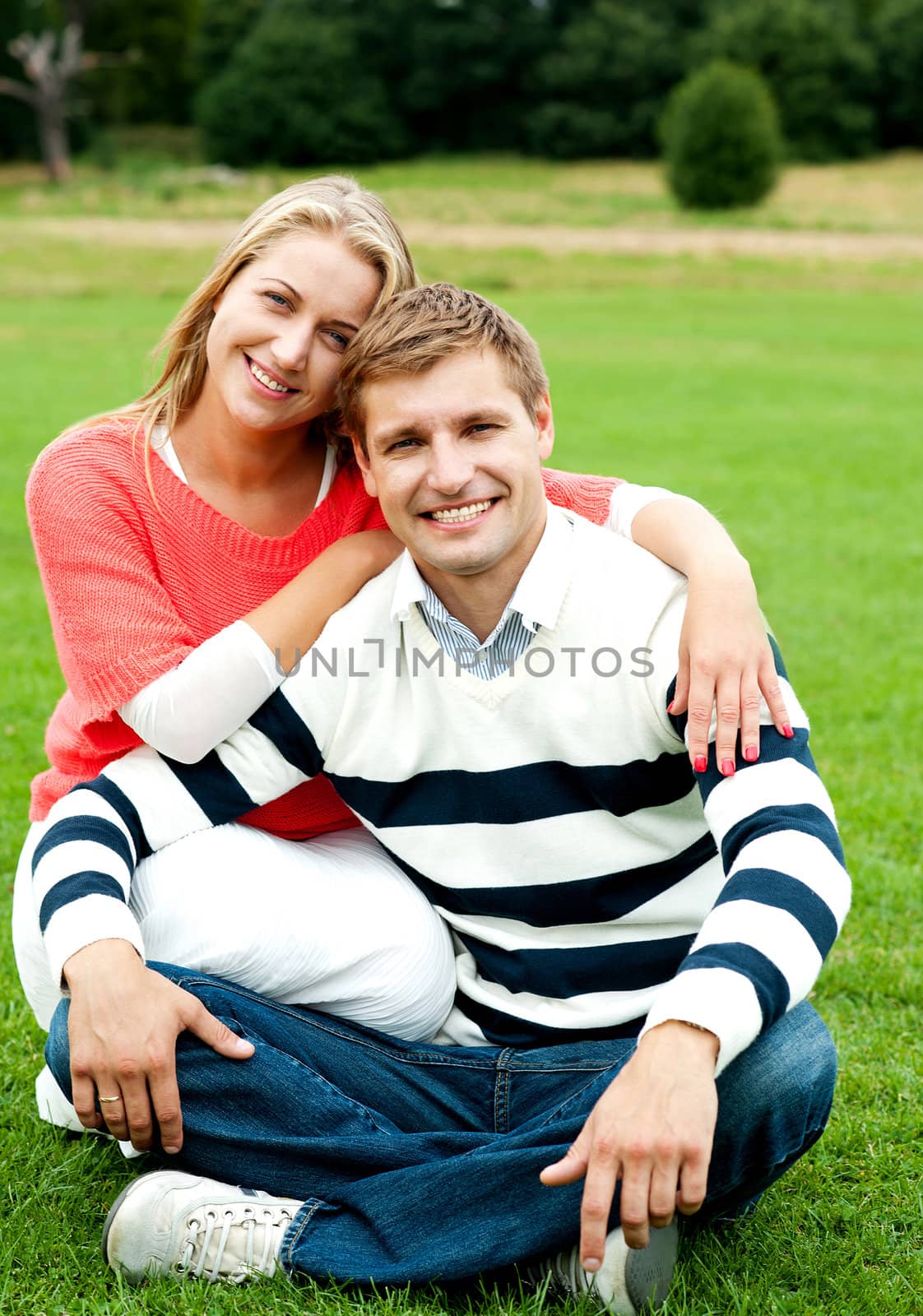 Adorable love couple, woman embracing her man by stockyimages