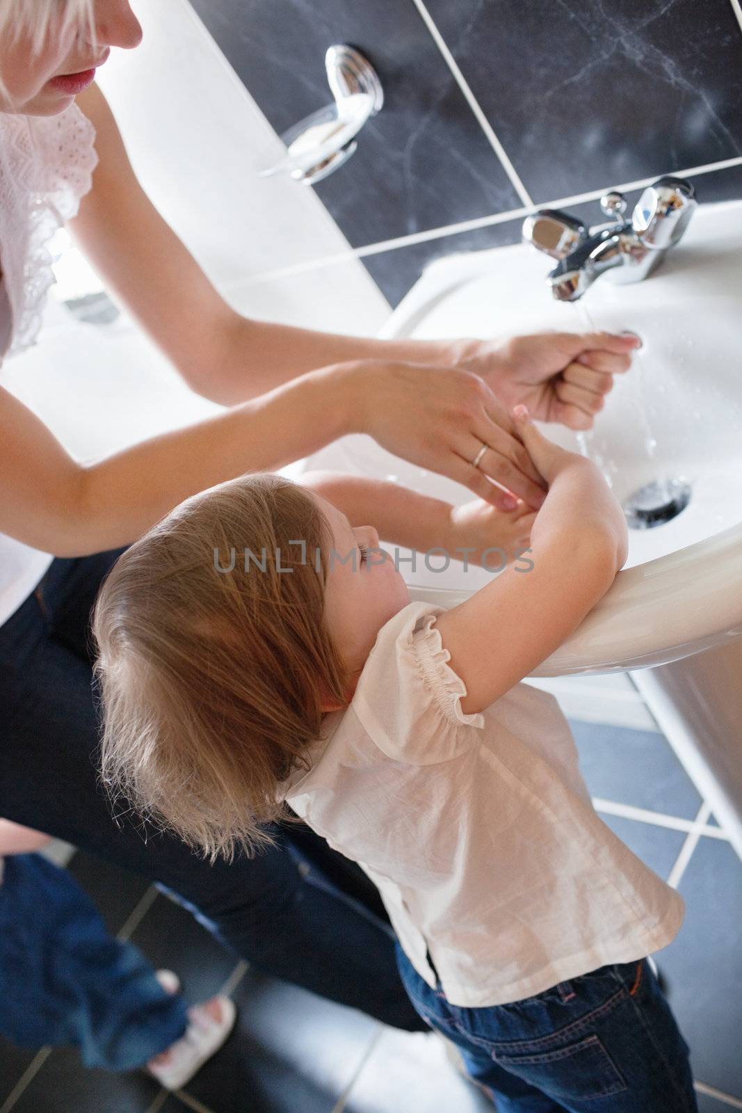 Family washing hands in the bathroom