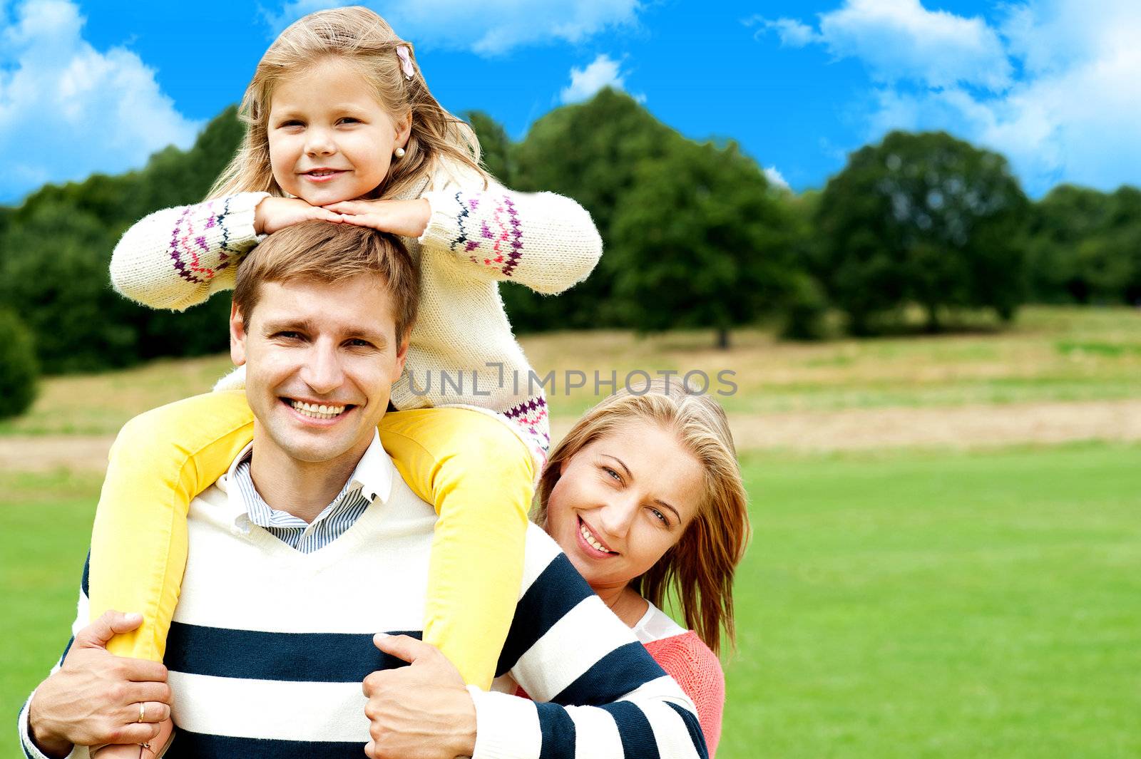 Happy smiling family outdoors by stockyimages