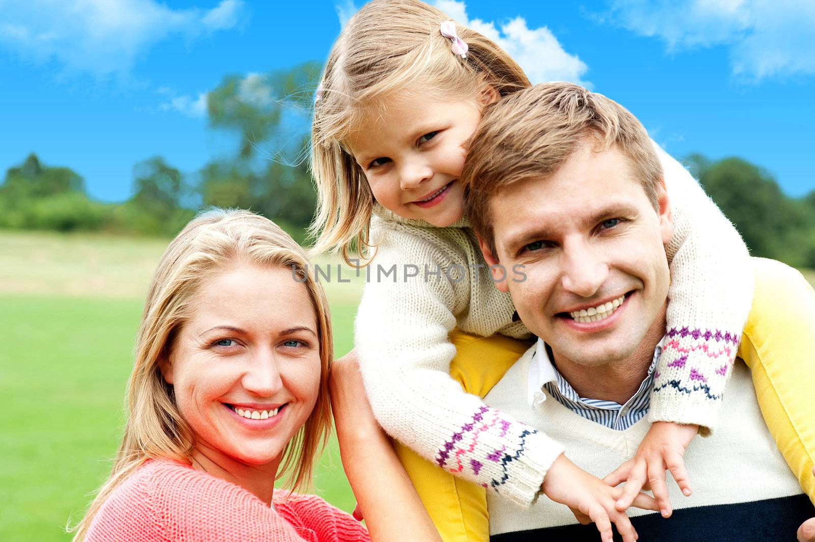 Beautiful happy caucasian family of three by stockyimages