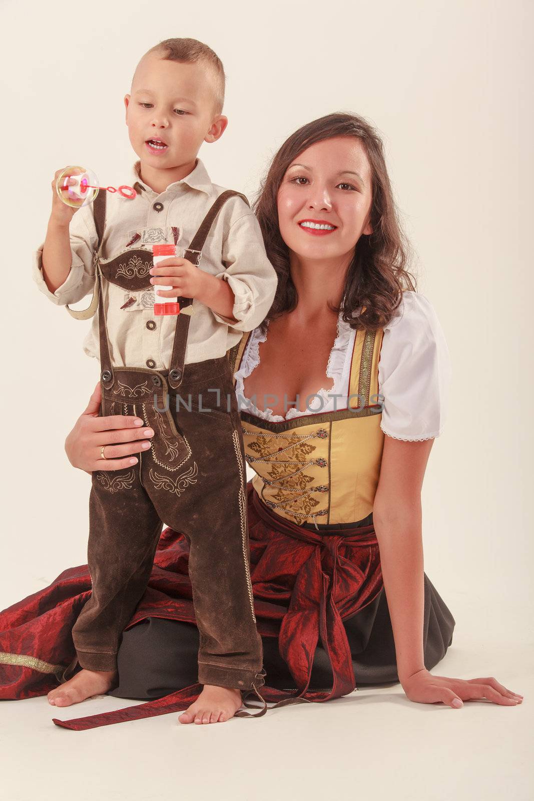 Bavarian mother in costume with your son at play