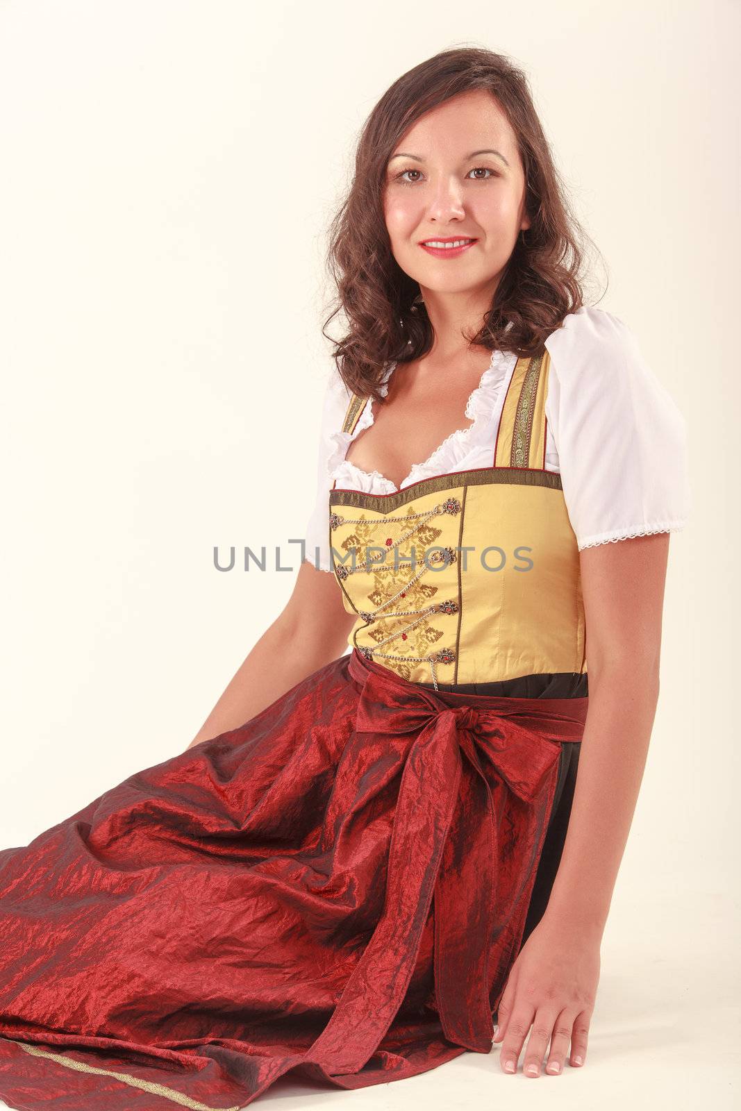 Bavarian beauty in costume sitting on the floor