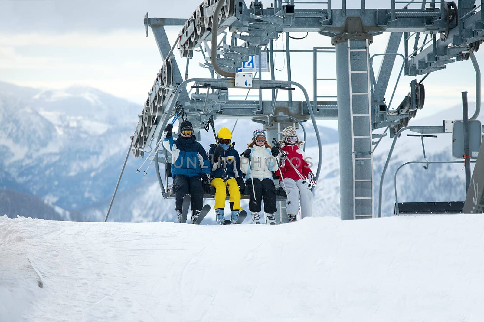 Skiers getting out the chair lift