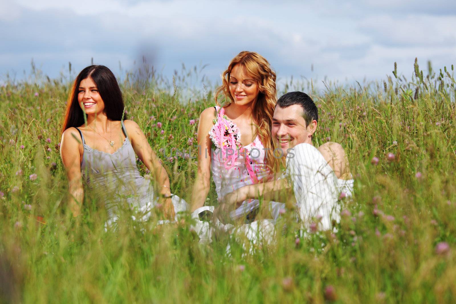 friends and dog in green grass field