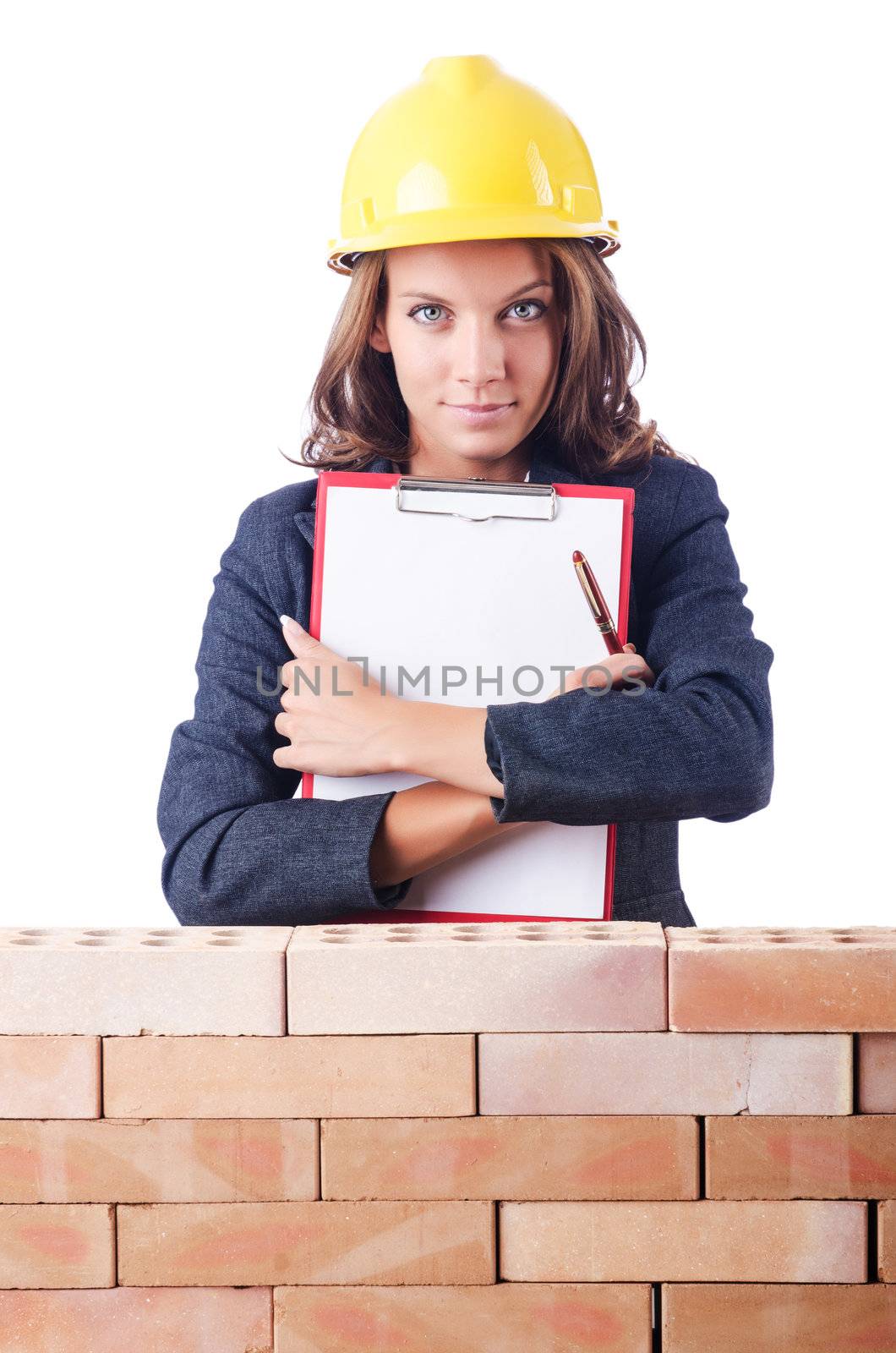 Woman builder and brick wall