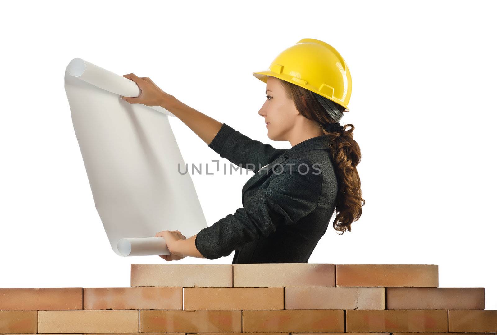 Businesswoman with drawings near brick wall