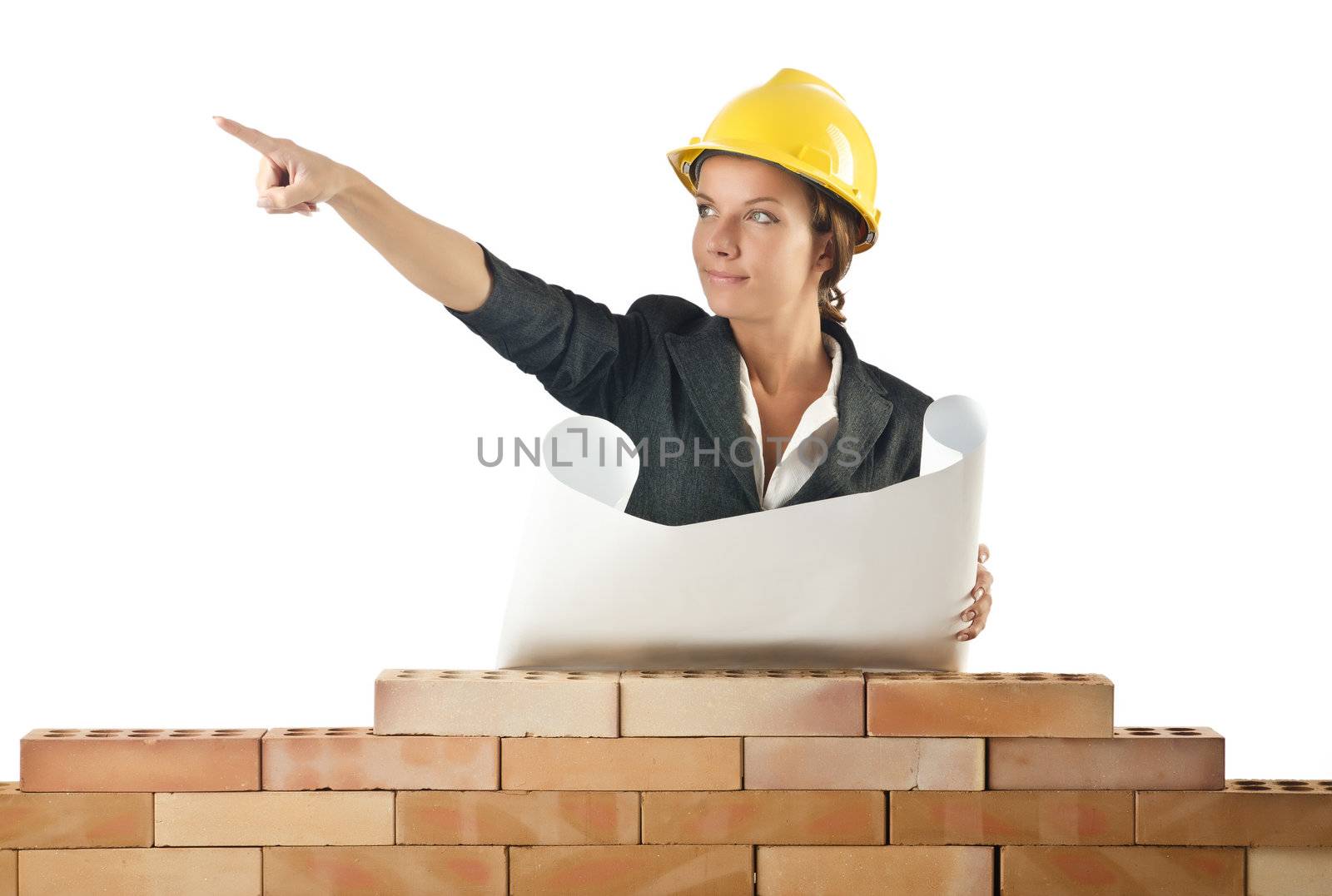 Businesswoman with drawings near brick wall